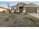 Charming home featuring a two-car garage and low maintenance desert landscaping at 20319 N 224Th Dr, Surprise, AZ 85387