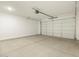 Spacious two car garage, featuring overhead door and lighting at 20319 N 224Th Dr, Surprise, AZ 85387