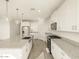 Well-lit, open kitchen with a central island, tile floors, and stainless steel appliances at 20319 N 224Th Dr, Surprise, AZ 85387