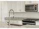 Close-up of kitchen details showcasing granite countertops, stainless appliances, and stylish fixtures at 20319 N 224Th Dr, Surprise, AZ 85387