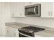 Modern kitchen showcasing stainless steel appliances, ample cabinet space, and stone countertops at 20319 N 224Th Dr, Surprise, AZ 85387