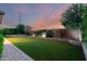 Large backyard with artificial turf, patio, and privacy wall at 21408 S 224Th Pl, Queen Creek, AZ 85142