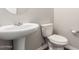 A half bathroom with a toilet and pedestal sink at 21408 S 224Th Pl, Queen Creek, AZ 85142
