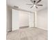 This bedroom features neutral carpet, a ceiling fan, and a closet at 21408 S 224Th Pl, Queen Creek, AZ 85142