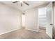 This bedroom offers a ceiling fan, carpeting, and doorways to two additional rooms at 21408 S 224Th Pl, Queen Creek, AZ 85142