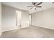 Empty bedroom with ceiling fan and neutral carpet at 21408 S 224Th Pl, Queen Creek, AZ 85142