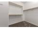 Bright walk-in closet features wood rod and white shelving for optimal organization at 21408 S 224Th Pl, Queen Creek, AZ 85142