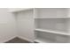 Bright and airy, this closet boasts built-in shelving and wood rod for easy storage at 21408 S 224Th Pl, Queen Creek, AZ 85142