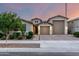Charming single-story home showcasing a well-manicured lawn, neutral color palette, and a three-car garage at 21408 S 224Th Pl, Queen Creek, AZ 85142