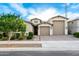 Charming single-story home showcasing a well-manicured lawn, neutral color palette, and a three-car garage at 21408 S 224Th Pl, Queen Creek, AZ 85142