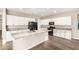 Stylish kitchen with white cabinetry, granite counters, an island with a sink, and stainless steel appliances at 21408 S 224Th Pl, Queen Creek, AZ 85142