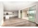 Bright, open living area seamlessly connecting kitchen, dining, and living spaces, with sliding doors to the patio at 21408 S 224Th Pl, Queen Creek, AZ 85142