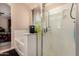 Bathroom featuring a shower with glass doors, a built-in bathtub, and neutral colors for a soothing ambiance at 2315 W Beverly Rd, Phoenix, AZ 85041
