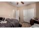 Neutral bedroom featuring a ceiling fan, sliding closet doors, and a door leading to another room in the house at 2315 W Beverly Rd, Phoenix, AZ 85041