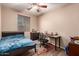 Bedroom showcasing a desk, window with blinds, and a bed, designed to create a comfortable living space at 2315 W Beverly Rd, Phoenix, AZ 85041