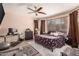 Bedroom featuring laminate flooring, ceiling fan, and large window bringing in natural light at 2315 W Beverly Rd, Phoenix, AZ 85041