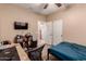 Cozy bedroom with laminate floors, a ceiling fan, and a convenient closet for storage at 2315 W Beverly Rd, Phoenix, AZ 85041