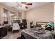 Inviting bedroom with a ceiling fan, desk area, and a comfortable bed, perfect for relaxation and productivity at 2315 W Beverly Rd, Phoenix, AZ 85041