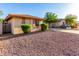Inviting one-story home featuring low-maintenance desert landscaping with mature trees for added shade at 2315 W Beverly Rd, Phoenix, AZ 85041