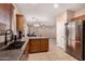 Cozy kitchen featuring stainless steel appliances, wood cabinets, and a view of the living space at 2315 W Beverly Rd, Phoenix, AZ 85041