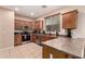 Well-equipped kitchen featuring wood cabinets, stainless steel appliances, and tiled countertops at 2315 W Beverly Rd, Phoenix, AZ 85041
