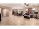 Open-concept living space with tile flooring, neutral walls, modern ceiling fan, and view of kitchen at 2315 W Beverly Rd, Phoenix, AZ 85041