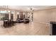 Spacious living area featuring neutral paint, ceiling fan, tile floors, and sliding door to the backyard at 2315 W Beverly Rd, Phoenix, AZ 85041