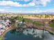 Aerial view featuring community, lake, golf course, and distant mountain views at 2537 N Miller Rd, Scottsdale, AZ 85257