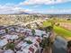Expansive aerial view of the residential area showcasing red tile roofs, mature trees, and a nearby golf course at 2537 N Miller Rd, Scottsdale, AZ 85257