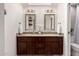 Well-lit bathroom featuring double sinks, granite countertops, and modern light fixtures at 2537 N Miller Rd, Scottsdale, AZ 85257