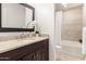 Bathroom featuring granite countertops and tiled shower with tub at 2537 N Miller Rd, Scottsdale, AZ 85257