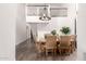 Bright dining room featuring a wooden table, six chairs, and a modern chandelier under a high ceiling at 2537 N Miller Rd, Scottsdale, AZ 85257