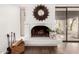 Close-up of a cozy fireplace, featuring decorative mirror, wood accents, and stylish accessories at 2537 N Miller Rd, Scottsdale, AZ 85257