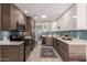 Modern kitchen with stainless steel appliances, two-tone cabinets, and a stylish backsplash at 2537 N Miller Rd, Scottsdale, AZ 85257