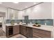 Bright kitchen features two-tone cabinets, modern appliances, quartz countertops, and a beverage cooler at 2537 N Miller Rd, Scottsdale, AZ 85257