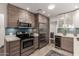 Bright kitchen features two-tone cabinets, stainless steel appliances, a skylight, and quartz countertops at 2537 N Miller Rd, Scottsdale, AZ 85257
