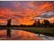 Beautiful sunset reflection on the community pond with lush landscaping at 2537 N Miller Rd, Scottsdale, AZ 85257