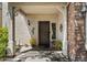 Inviting front porch features decorative details, neutral colors, and stylish exterior lighting at 26678 N Babbling Brook Dr, Phoenix, AZ 85083
