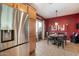 Open-concept kitchen with stainless steel refrigerator and a seamless flow to the dining area at 26678 N Babbling Brook Dr, Phoenix, AZ 85083