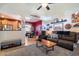 Cozy living room featuring ample seating, warm tones, and a seamless flow into the dining area at 26678 N Babbling Brook Dr, Phoenix, AZ 85083