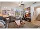 Spacious living room with comfortable seating, entertainment center, and easy access to the staircase at 26678 N Babbling Brook Dr, Phoenix, AZ 85083