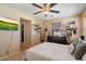 Comfortable bedroom with neutral tones, decorative shelving, and a ceiling fan at 26678 N Babbling Brook Dr, Phoenix, AZ 85083