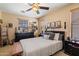 Comfortable bedroom with neutral tones, decorative shelving, and a ceiling fan at 26678 N Babbling Brook Dr, Phoenix, AZ 85083