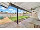 Wide backyard featuring artificial turf, gravel, and pavers under a covered patio with string lights at 2924 W Anderson Dr, Phoenix, AZ 85053