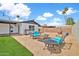 Outdoor space with gravel, artificial grass, patio furniture, and a fire pit at 2924 W Anderson Dr, Phoenix, AZ 85053