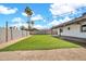 Backyard featuring lush artificial turf, a perimeter wall, and desert landscaping at 2924 W Anderson Dr, Phoenix, AZ 85053