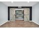 Interior view of the barn door closet with a black accent wall and engineered wood floors at 2924 W Anderson Dr, Phoenix, AZ 85053