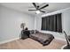This bedroom has a ceiling fan, wood flooring, and a black night stand with lamp at 2924 W Anderson Dr, Phoenix, AZ 85053