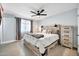 Inviting bedroom features a wood-framed bed, nightstands with lamps, and a ceiling fan at 2924 W Anderson Dr, Phoenix, AZ 85053