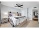 Bright bedroom with a wood-framed bed, nightstands, and a ceiling fan at 2924 W Anderson Dr, Phoenix, AZ 85053